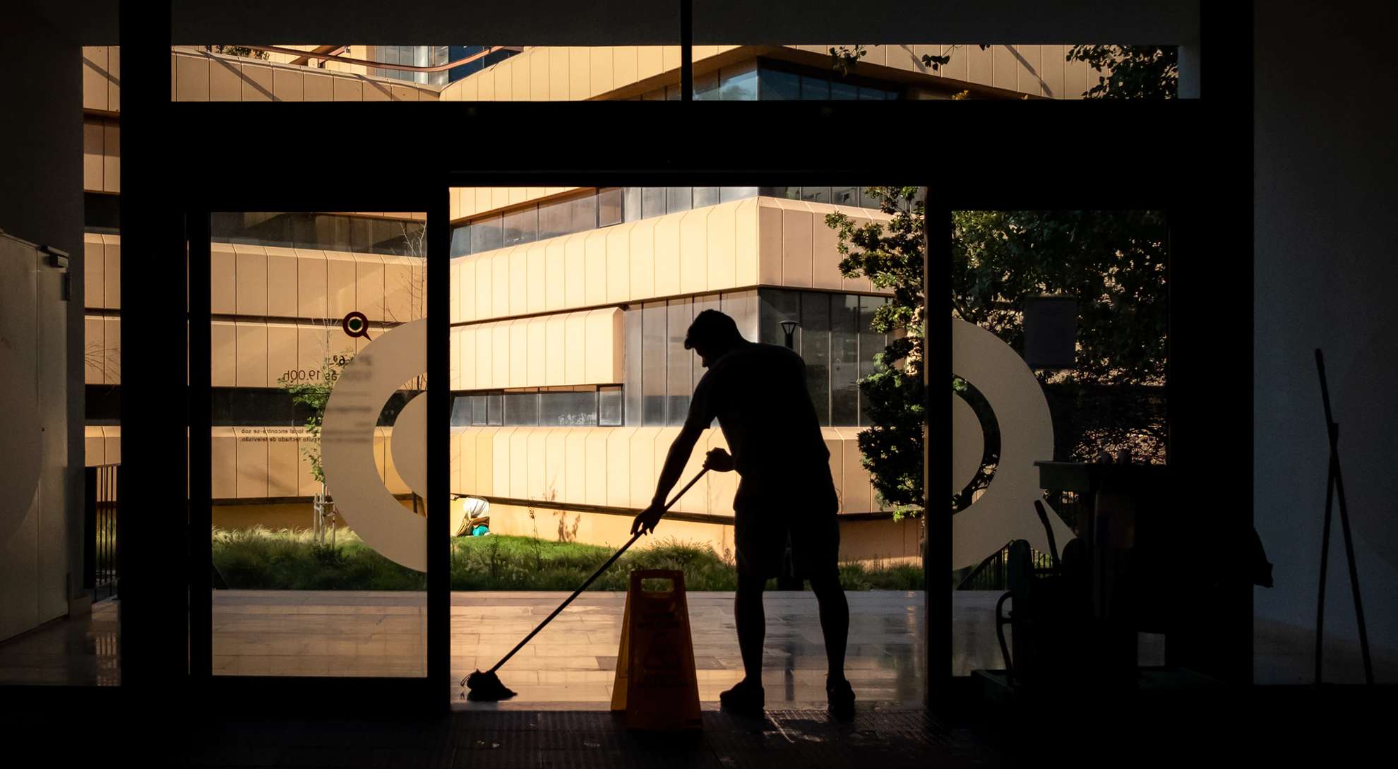 silhouette of janitor cleaning a commercial facility